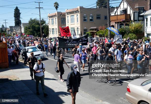 Demonstrators walk up Alcatraz Avenue in a march and rally against white supremacy and police violence in Berkeley, Calif. On Saturday, Sept. 23,...