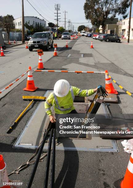 Zach Braun with Pinnacle Power installs P.G. & E. Power lines underground through a utility vault along Old County Rd. Near Harbor Boulevard with...