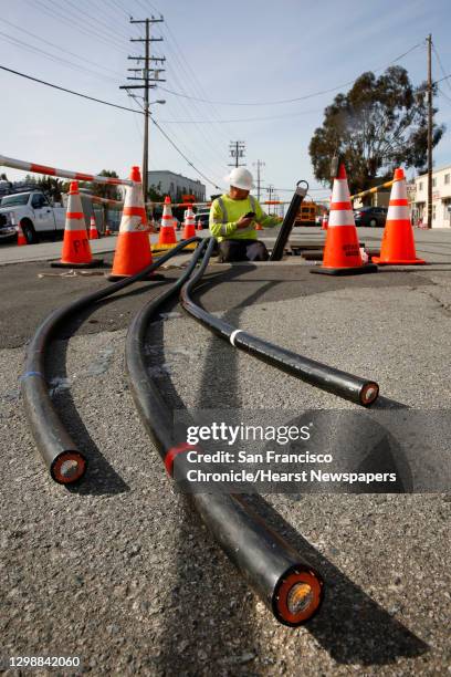 Zach Braun with Pinnacle Power helps to install P. G. And E. Power lines underground along Old Country Rd. Near Harbor Way, with plans on removing...