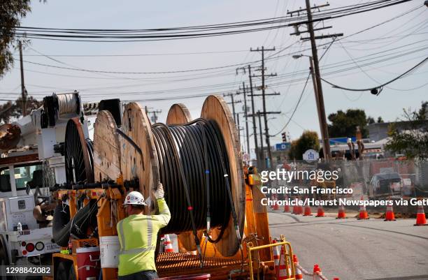 Huge spools of power lines are prepared to be installed as P.G. & E. Runs power lines underground along Old Country Rd. Near Harbor Way, with plans...