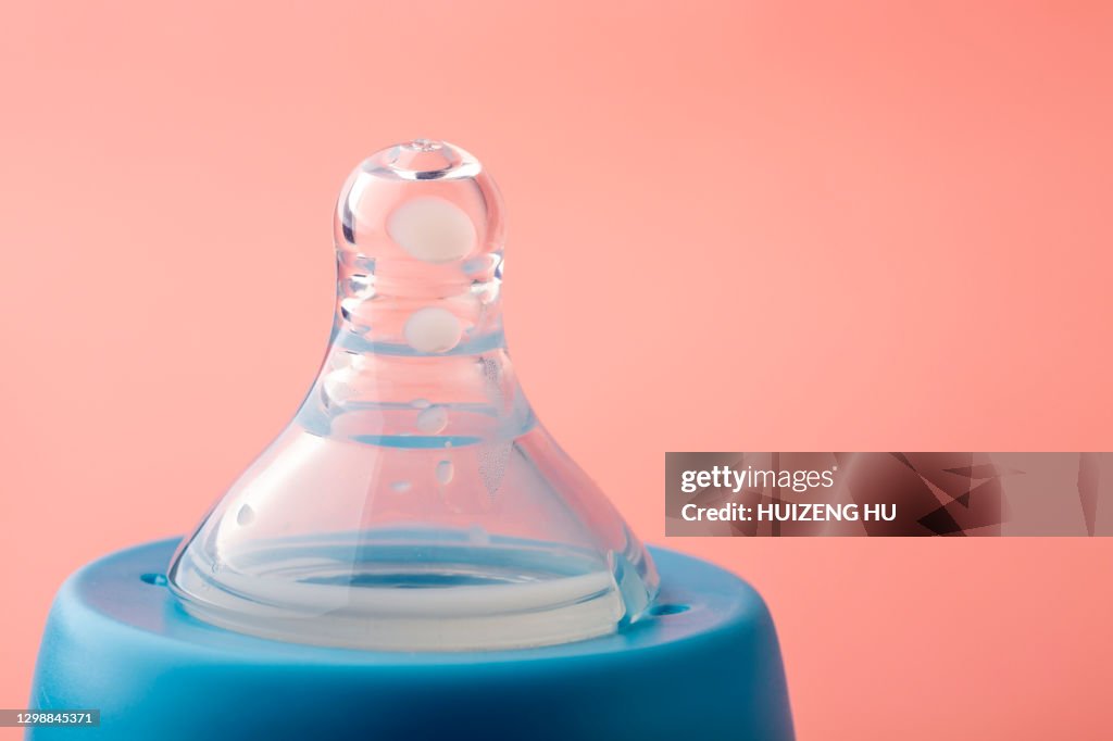 Close-up of pacifier on baby bottle