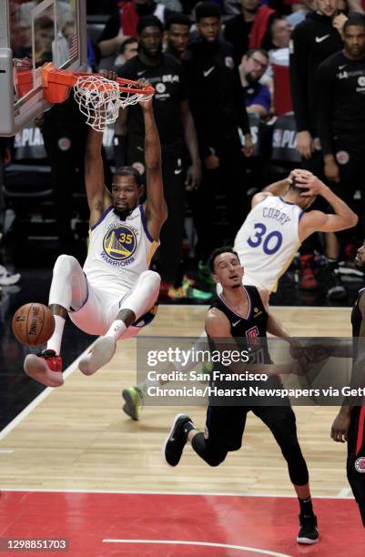Kevin Durant dunks on a pass from Stephen Curry late in the second half as the Golden State Warriors played the Los Angeles Clippers in Game 4 of the...