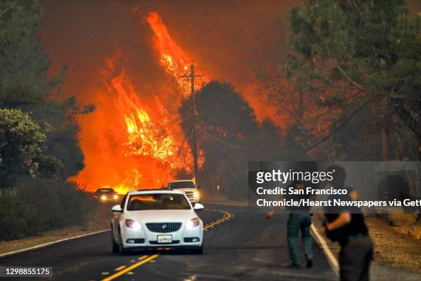Sheriffs yell to drivers to evacuate the area off of Pentz Road during the Camp Fire in Paradise, California, on Thursday, Nov. 8, 2018.