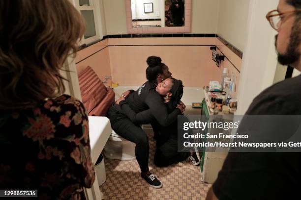 Stephanie Dixon left, and Deundra Hundon demonstrate how the woman giving birth can be supported while in the bathroom durning a birth training...