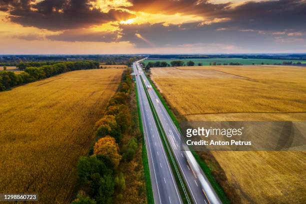 aerial view of the road between green fields at sunset - ukraine landscape bildbanksfoton och bilder
