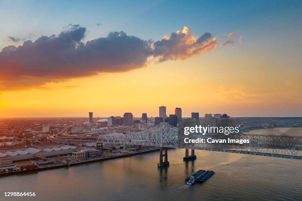 a ship is under the new orleans bridge in the evening from above - new orleans stock-fotos und bilder