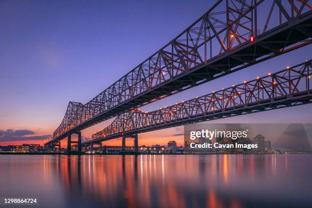 the new orleans bridge in the evening - green bridge over trees stock pictures, royalty-free photos & images