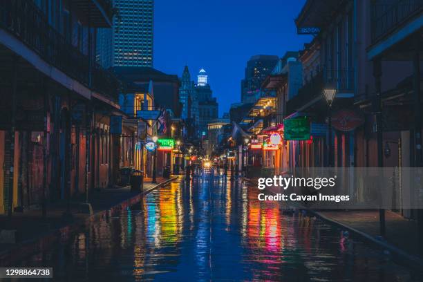 the famous bourbon street in new orleans without people in the morning - downtown neon stock-fotos und bilder