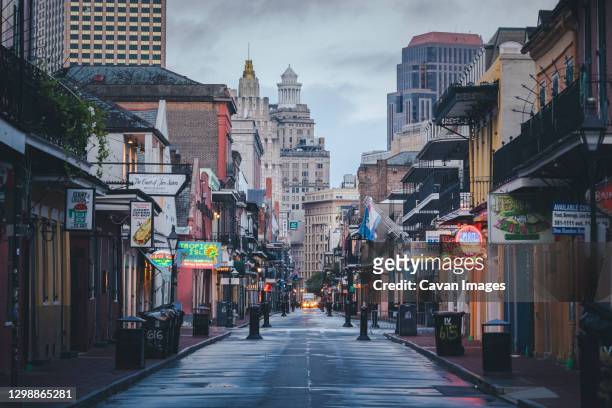 the famous bourbon street in new orleans without people in the morning - new orleans stock pictures, royalty-free photos & images