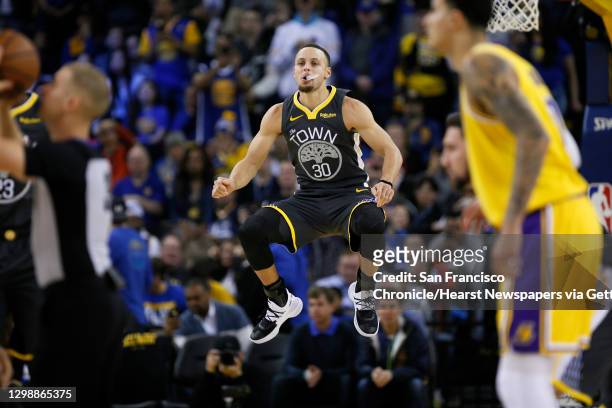 Golden State Warriors guard Stephen Curry warms up before tip off in the first half of an NBA game against the Los Angeles Lakers at Oracle Arena on...