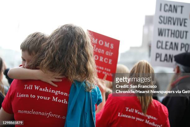 Samantha Deputy , with Moms Clean Air Force, holds Michael Lesiuk both of Reno, NV., as they stand on the top of the steps outside City Hall with...