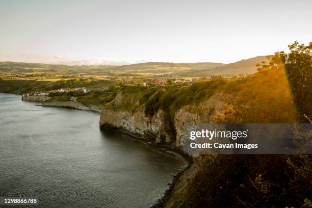view of robins hood's bay from a distance at sunset - north york moors national park at night stock pictures, royalty-free photos & images