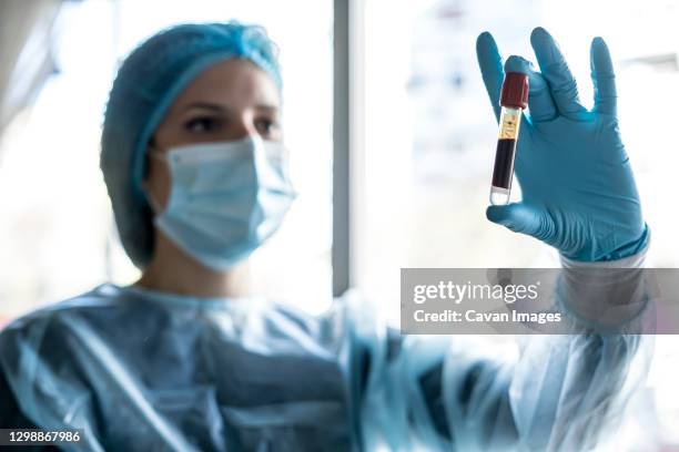 medical doctor or laborant holding tube with ncov coronavirus vaccine for 2019-ncov virus. - laborant stock pictures, royalty-free photos & images