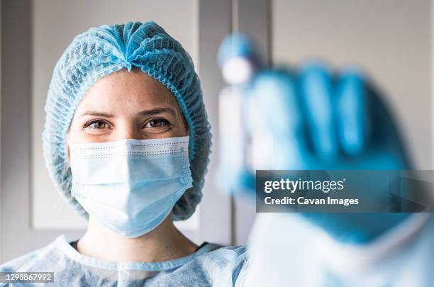 medical doctor or laborant holding tube with ncov coronavirus vaccine for 2019-ncov virus. - laborant stock pictures, royalty-free photos & images