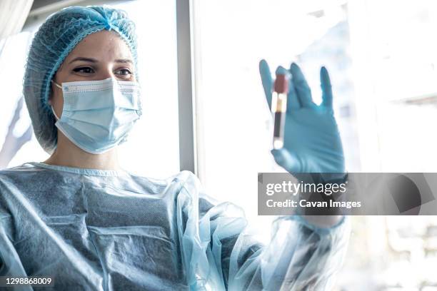 medical doctor or laborant holding tube with ncov coronavirus vaccine for 2019-ncov virus. - laborant stock pictures, royalty-free photos & images