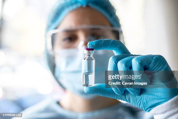 medical doctor or laborant holding tube with ncov coronavirus vaccine for 2019-ncov virus. - laborant stock pictures, royalty-free photos & images