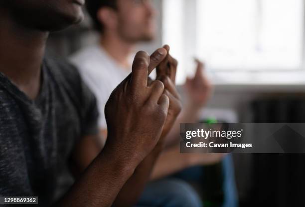 crop black man wishing for goal with friend - watching game stock pictures, royalty-free photos & images