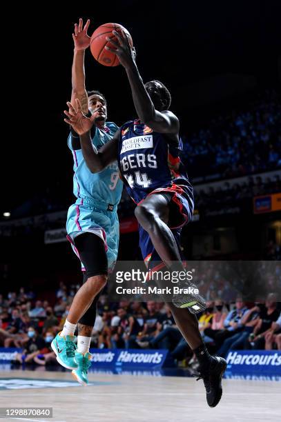 Sunday Dech of the 36ers heads for the basket defended by Corey Webster of the Breakers during the round three NBL match between the Adelaide 36ers...