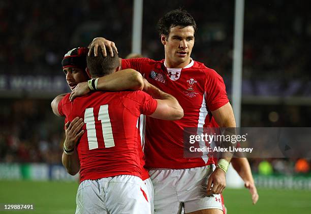 Wing Shane Williams of Wales is congratulated by teammates Leigh Halfpenny and Mike Phillips after scoring a try during the 2011 IRB Rugby World Cup...