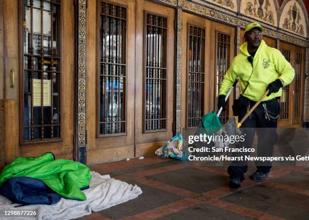 Castro Community Benefit District cleaning ambassador Derron Jones cleans up the belongings and bedding of a homeless person abandoned in front of...