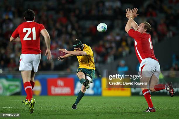 Centre Berrick Barnes of the Wallabies kicks a drop goal during the 2011 IRB Rugby World Cup bronze final match between Wales and Australia at Eden...