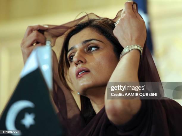 Pakistan's Foreign Minister Hina Rabbani Khar speaks as she adjusts ...