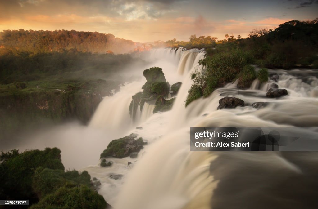 Iguazu falls waterfalls at sunset.