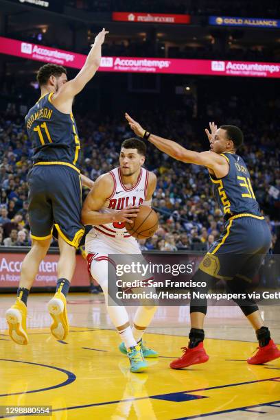 Golden State Warriors guard Klay Thompson and guard Stephen Curry defend Chicago Bulls guard Zach LaVine in the first half of an NBA game at Oracle...