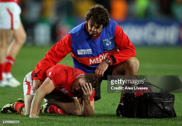 Shane Williams of Wales lies dejected as he is comforted by team physio Mark Davies during the 2011 IRB Rugby World Cup bronze final match between...