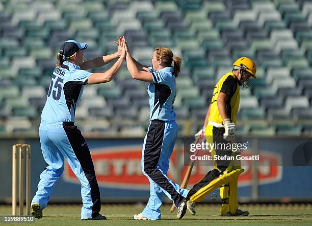 Claire Koski and Sarah Coyte of the Breakers celebrate after the dismissal of Nicky Shaw of the Fury during the Women's Twenty20 match between the...