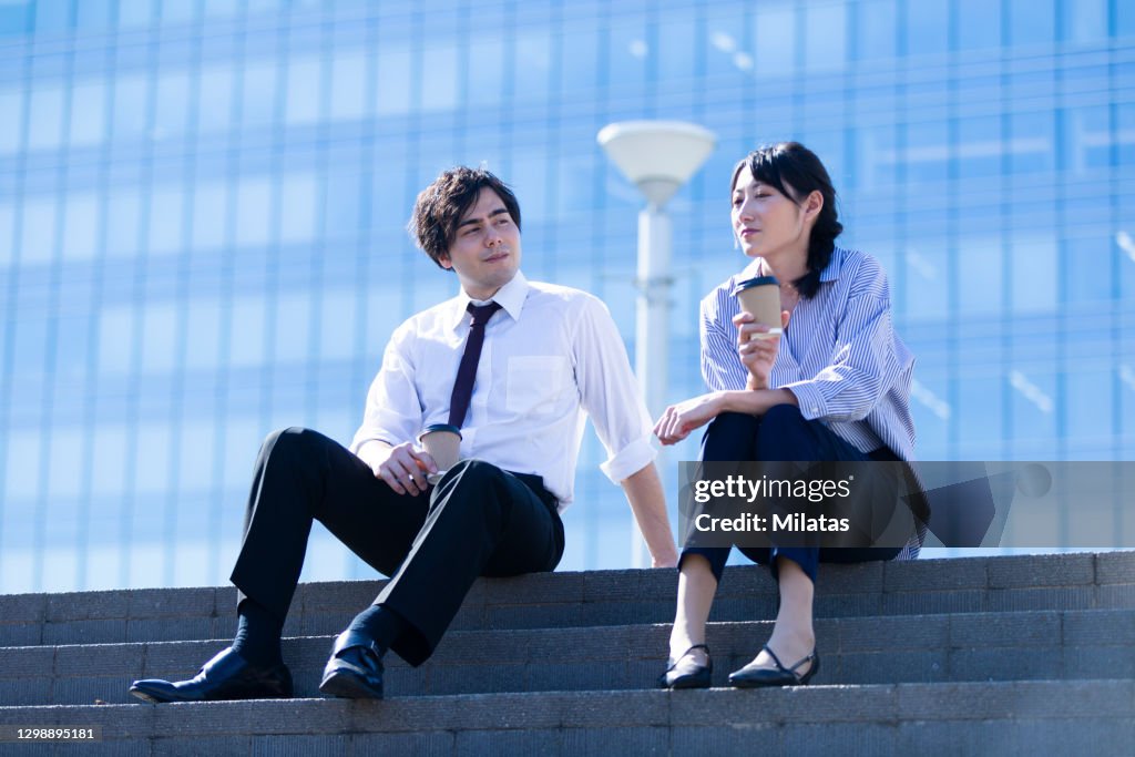 Men and women sitting on the steps