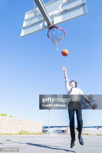 a man playing basketball in the park - 社会人 ストックフォトと画像