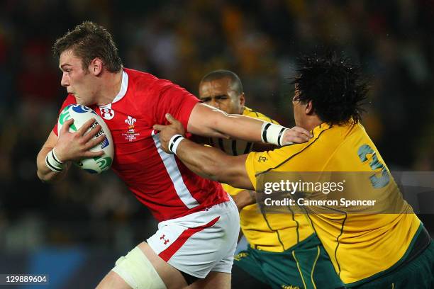 Dan Lydiate of Wales is tackled by Salesi Ma'afu of the Wallabies during the 2011 IRB Rugby World Cup bronze final match between Wales and Australia...