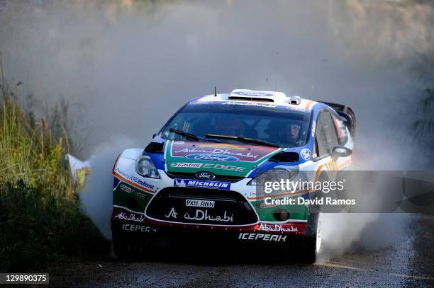 Mikko Hirvonen of Finland and Jarmo Lehtinen of Finland compete in their Ford Abu Dhabi WRT Ford Fiesta RS WRC during the second stage of the first...