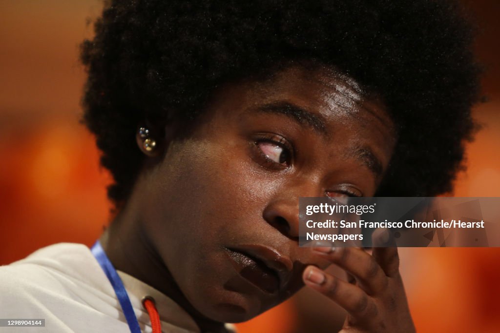 Ola Jackson, a senior at Rainier Beach High School, wipes away a tear as she speaks about the loss of two of her family members to gun violence as she and other supporters of Washington State Initiative 1639, which will enact waiting periods and backgroun