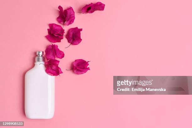 white perfume bottle on pink background - cologne bottle stock pictures, royalty-free photos & images