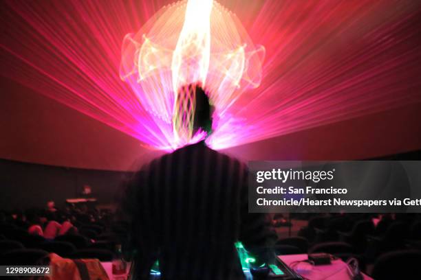 Local music artist and DJ Stastia Irons, aka Stas THEE Boss, performs during a laser light show at the Pacific Science Center, April 5, 2018.