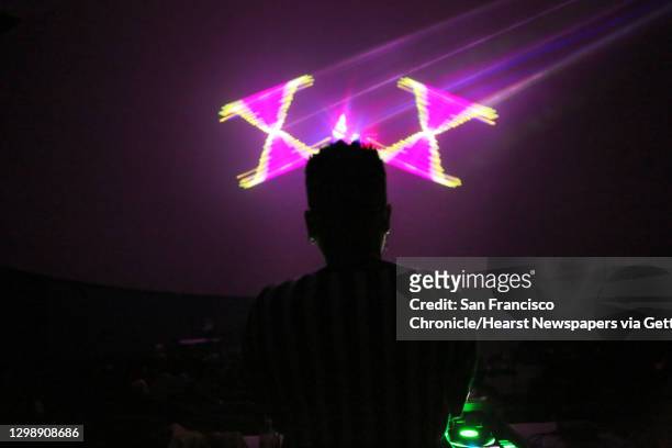 Local music artist and DJ Stastia Irons, aka Stas THEE Boss, performs during a laser light show at the Pacific Science Center, April 5, 2018.
