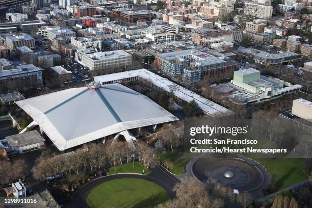 Key Arena and the International Fountain are seen from above as members of the pyrotechnic crew install fireworks atop the Space Needle in...
