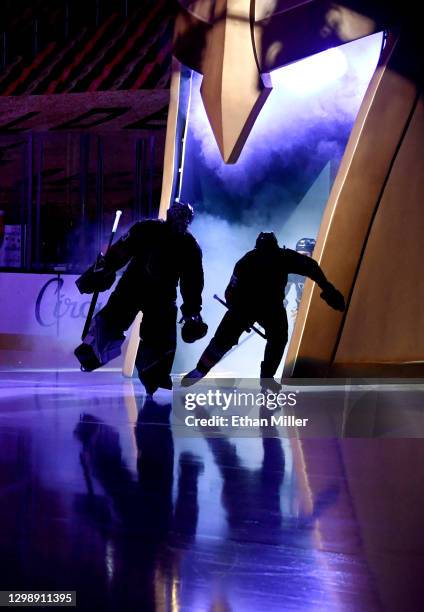 Robin Lehner and Ryan Reaves of the Vegas Golden Knights are silhouetted as they take the ice for a game against the St. Louis Blues at T-Mobile...