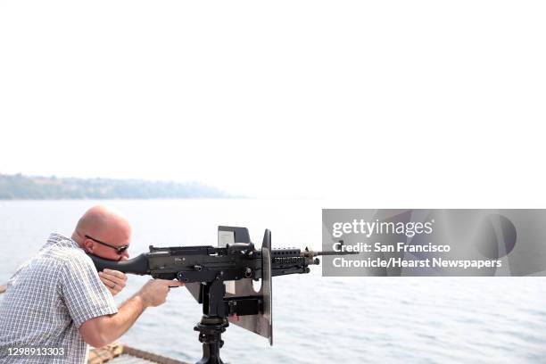 Tim Garchow, of Tacoma, tries his hand at manning an M240 machine gun aboard the USS Anchorage during the Seafair Parade of Ships on Wednesday,...