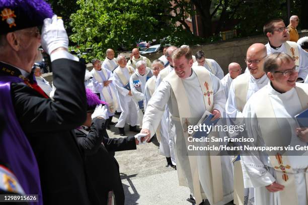 Flanked by the Knights of Columbus, priests make their way into the cathedral before the ordination of Daniel H. Mueggenborg as bishop, Wednesday,...