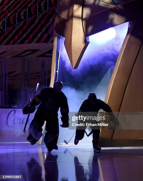 Robin Lehner and Ryan Reaves of the Vegas Golden Knights are silhouetted as they take the ice for a game against the St. Louis Blues at T-Mobile...