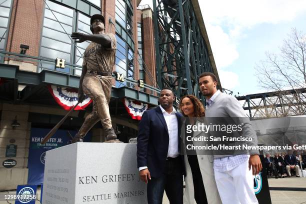 Former Mariner Ken Griffey Jr. Poses with his wife Melissa and son Trey next to a new statue in his likeness outside Safeco Field, April 13, 2017....