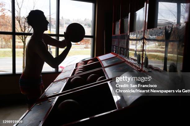 Lorenzo Hernandez shoots hoops during the Cupid's Undie Run, an annual fundraiser for The Children?s Tumor Foundation and neurofibromatosis research,...