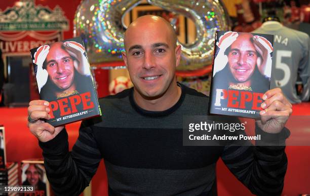 Pepe Reina of Liverpool signs copies of his Autobiography at the club store at Anfield on October 20, 2011 in Liverpool, England.