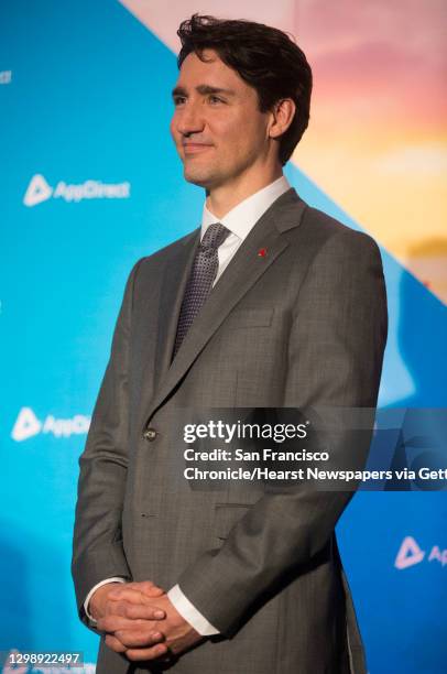 Canadian Prime Minister Justin Trudeau listens as AppDirect President and Co-CEO Daniel Saks speaks during a visit to the AppDirect office Thursday,...