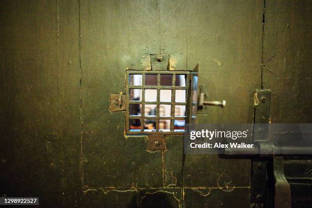 old wooden prison door window grid. - dirty prison cell stock pictures, royalty-free photos & images