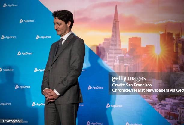 Canadian Prime Minister Justin Trudeau listens as AppDirect President and Co-CEO Daniel Saks speaks during a visit to the AppDirect office Thursday,...