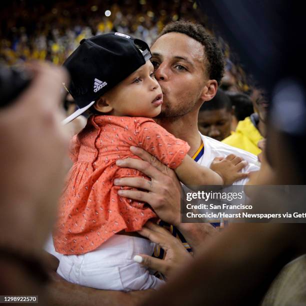 Golden State Warriors��� Stephen Curry kisses his daughter, Riley, after the Warrior's 104 to 90 victory over the Houston Rockets during Game 5 of...